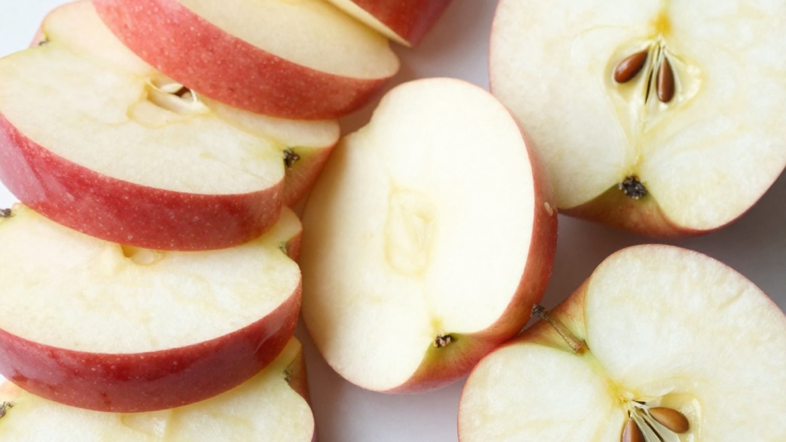 Fresh apple slices with without peel, showing the proper preparation for hamster feeding